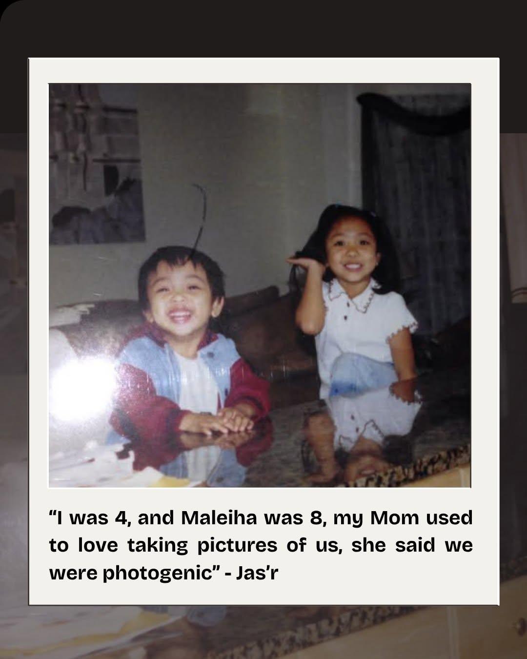 Maleiha as a young girl sitting on a couch beside her younger brother, both grinning at the camera.