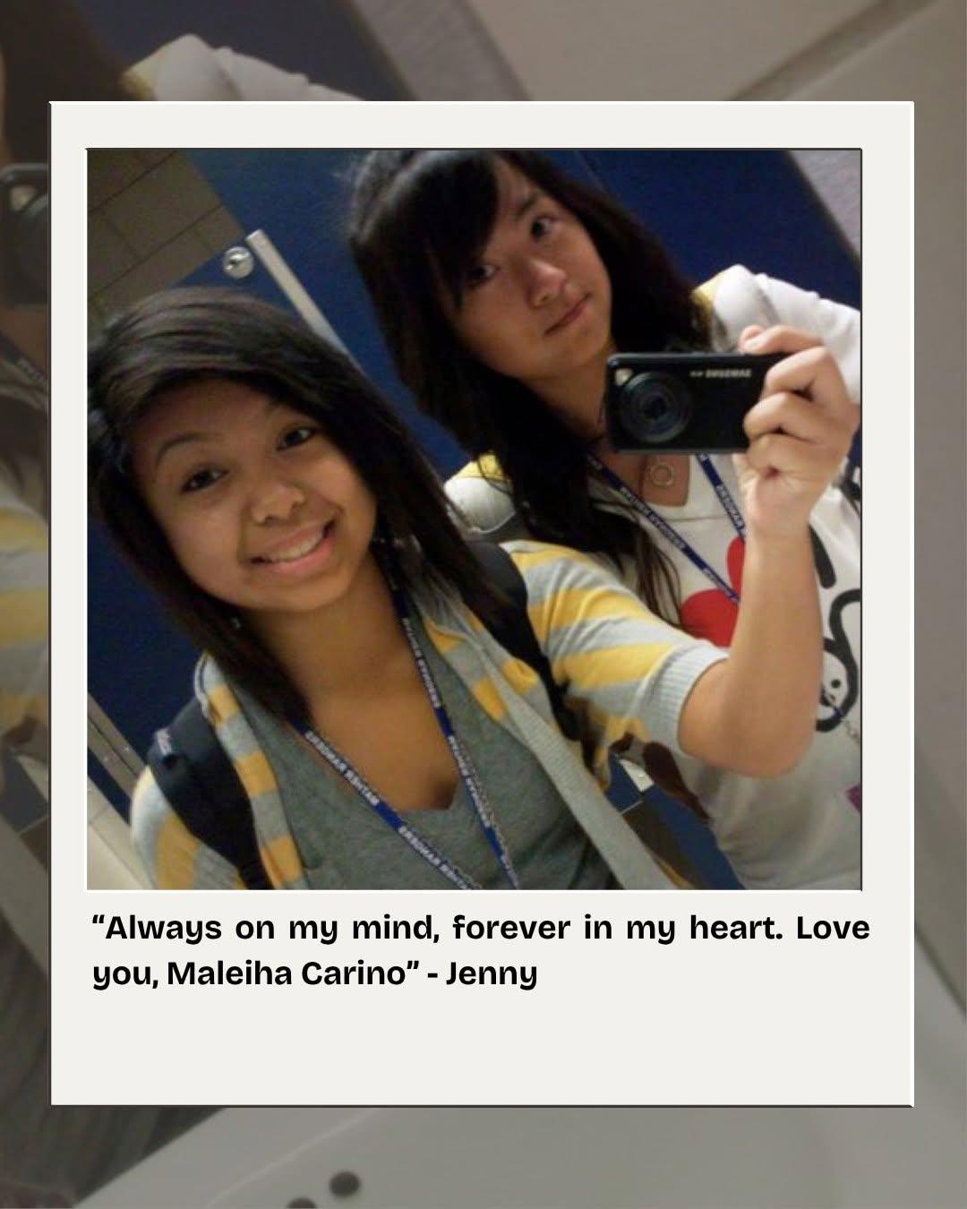 Maleiha and a friend taking a mirror selfie in a school hallway.